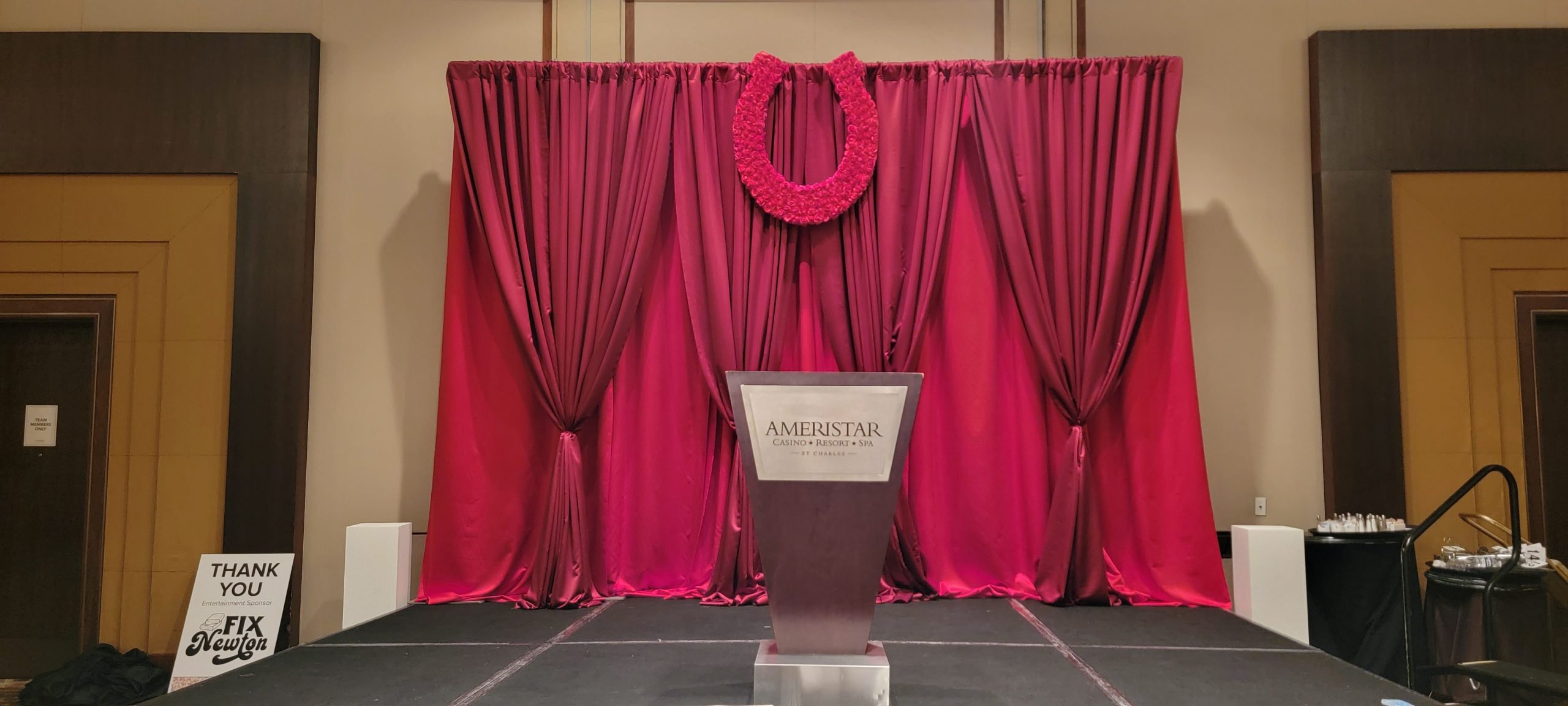 Custom event stage with floral horseshoe